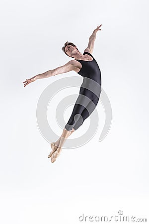 Ballet Dancer Young Man in Black Dance Suit Posing in Flying Ballanced Dance Pose Studio Stock Photo