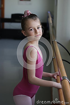 Ballet girl standing next to the barre Stock Photo