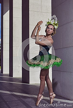 Dancing Ballet Ideas. Winsome Professional Caucasian Ballet Dancer in Green Tutu Dress Posing On Dancing Pose While Wearing Stock Photo