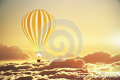 Balloon above the clouds at sunset Stock Photo