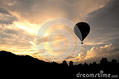 Balloon flying on sky in evening time Silhouette style Stock Photo