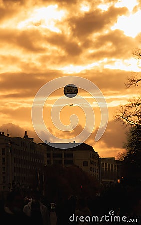 A balloon in the sunset sky in the city Editorial Stock Photo