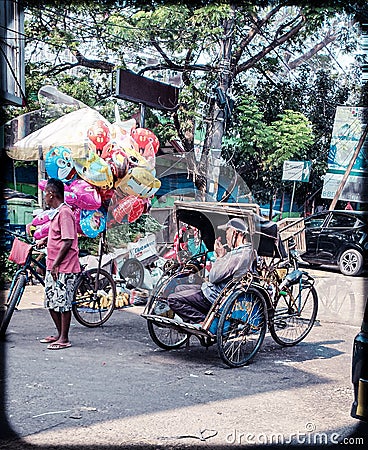 balloon traders and pedicab drivers who are waiting for customers Editorial Stock Photo