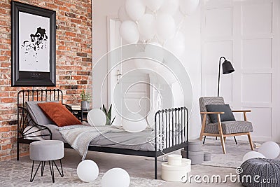 Balloons in industrial stylish bedroom, real photo with copy space Stock Photo