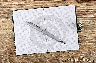 Ballpoint on opened notepad on table. Top view Stock Photo