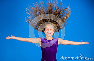 Ballroom latin dance hairstyles. Kid girl with long hair wear dress on blue background. Hairstyle for dancer. How to Stock Photo