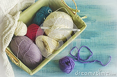 Balls of colored thread lying in a rectangular basket. Stock Photo