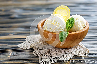 Balls of lemon ice cream in a wooden bowl. Stock Photo