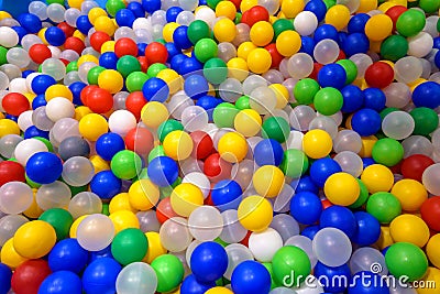 Balls in playground for colorful background. Dry plastic pool with many small balls for play. Pattern with plastic color balls in Stock Photo
