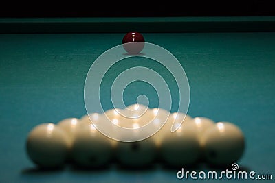 Balls for Russian Billiards are lined with a pyramid at the beginning of the game. white balls on a green table. serious sport, Stock Photo