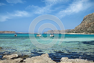 Balos lagoon on Crete island in Greece. Tourist boats in crystal clear water. Stock Photo