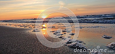 Baltic sunset among waves Stock Photo