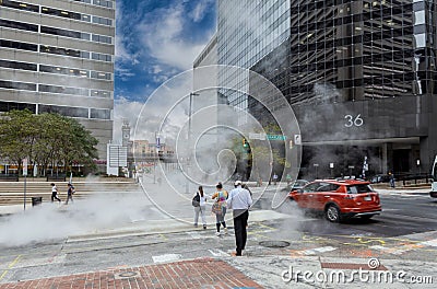 Baltimore Cityscape with People and Traffic in Background. People Crossing Street. Baltimore Downtown. Pipe Vapour Steam Editorial Stock Photo