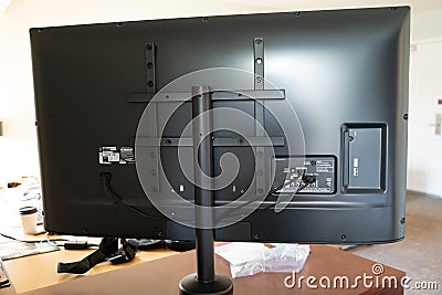 Baltimore, Maryland - May 14, 2019: Back view of a modern LG Flatscreen HDTV, showing cables, plugs, HDMI cords. Television is Editorial Stock Photo