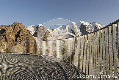 Balustrade in the alps with glacier covered mountains Stock Photo