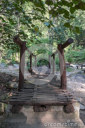 Bamboo bridge used to walk across to the green forest Stock Photo