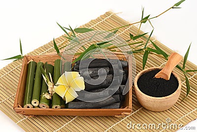 Bamboo Charcoal, fresh, dried, green leaves and powder on a white background. Stock Photo
