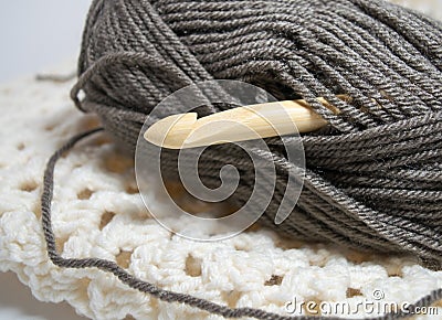 Bamboo Crochet hook in brown yarn Stock Photo