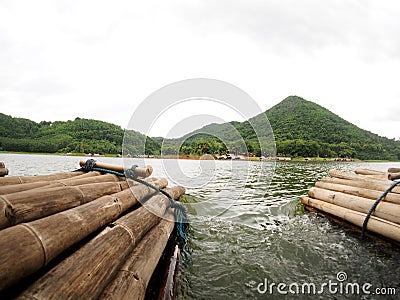 Bamboo floating raft in high mountain lake panorama view Stock Photo