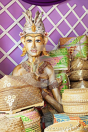 Bamboo offering boxes and traditional ceremonial balinese man figure Stock Photo