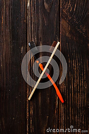 Bamboo and plastic toothbrushes crosswise, top view Stock Photo