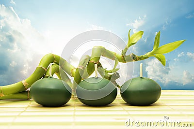 Bamboo and three green candle with clouds and sunlight ourdoors Stock Photo