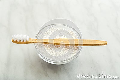 Bamboo toothbrush, dentifrice tooth powder on white marble background. Biodegradable natural bamboo toothbrush. Eco friendly, Zero Stock Photo