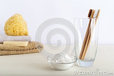 Bamboo toothbrushes in glass, dentifrice tooth powder on white background witn natural bath products. Biodegradable natural bamboo Stock Photo