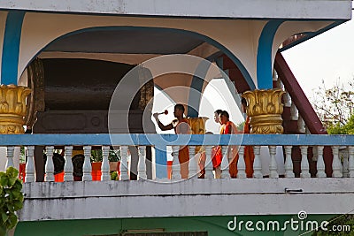 Ban Houei Sai Laos 12/23/2011 Buddhist monks in robes beating ceremonial drum Editorial Stock Photo