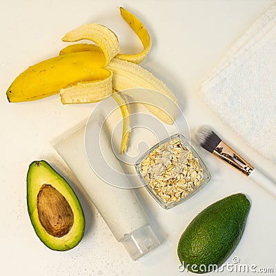 Banana and avocado for a handmade face mask and ingredients on a white table. Skin care. Stock Photo