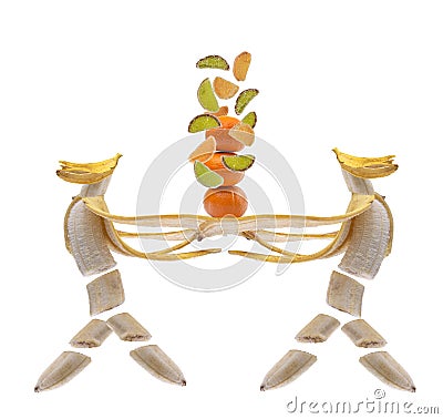 A banana in the form of a human figure carrying tangerines with flying slices of marmalade on an isolated white background Stock Photo