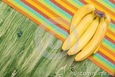 Banana on a green chalkboard on colored napkin left space for te Stock Photo