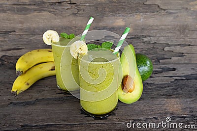 Banana Juice and avocado smoothies and green juice drink healthy, delicious taste in a glass for weight loss on wooden background Stock Photo