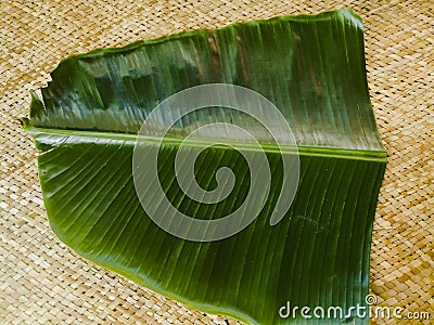 Banana leaf for Onam sadhya placed on a mat. Stock Photo