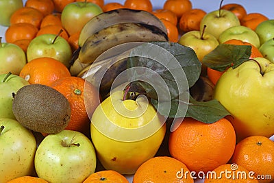 banana, orange, quince, apple, tangerine, kiwi are mixed tasty fruit composition on background. Stock Photo