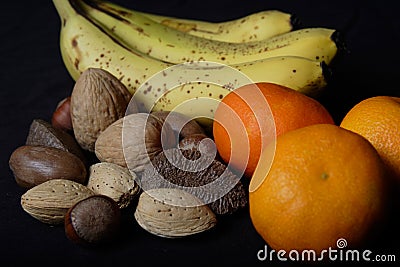Banana, oranges and mixed nuts Stock Photo