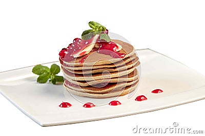 Banana pancakes with jam and mint leaves. Homemade pancakes with red jam in isolation on a white plate Stock Photo