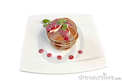 Banana pancakes with jam and mint leaves. Homemade pancakes with red jam in isolation on a white plate. Top view Stock Photo