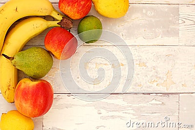 Banana, pear, lime, apples and lemons in the corner on the wooden background Stock Photo