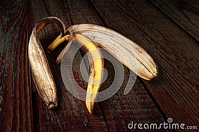 Banana peel. Close-up of an overripe banana peel on a dark wooden background Stock Photo