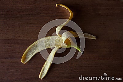 Banana rind on a brown wooden table. Stock Photo