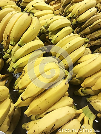 bananas on display in produce. yellow fruits with bright colors. Stock Photo