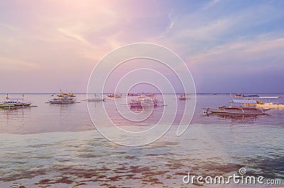 Banca boats anchored in the lagoon at Panglao Island in evening light. Bohol, Philippines Stock Photo