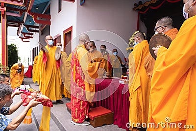 Chief monks lead the praying process for the visitors and the servant Editorial Stock Photo