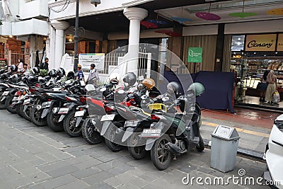 motorbike parking along the shops on Jalan Braga, Bandung Editorial Stock Photo