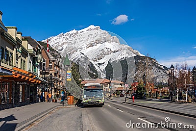 Banff Avenue bus stop, street view of Town of Banff. Banff National Park, Canadian Rockies. Editorial Stock Photo