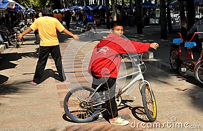 Bang Saen, Thailand: Boy on Bicycle on Promenade Editorial Stock Photo