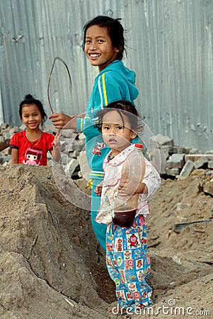 Bang Saen, Thailand: Little Girls Playing in Sand Pile Editorial Stock Photo