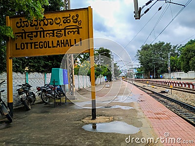 Closeup of Lottegollahalli Railway Station with Yellow and black Color Name Board Editorial Stock Photo