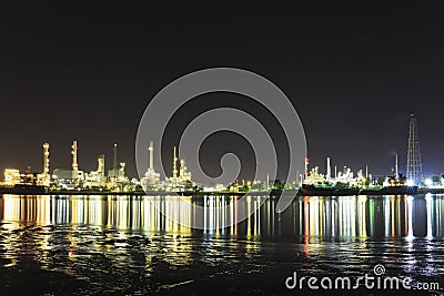 Bangchak Petroleum's oil refinery in Silhouette, beside the Chao Phraya River Editorial Stock Photo